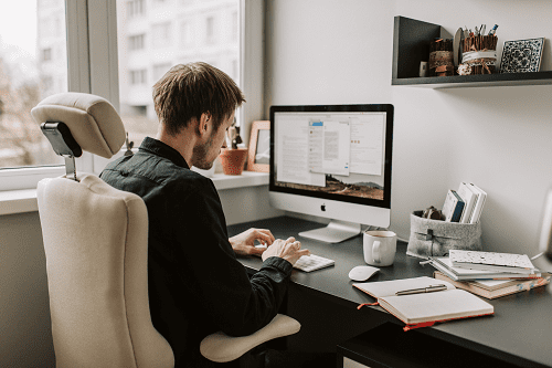 An employee working on a computer at a desk.