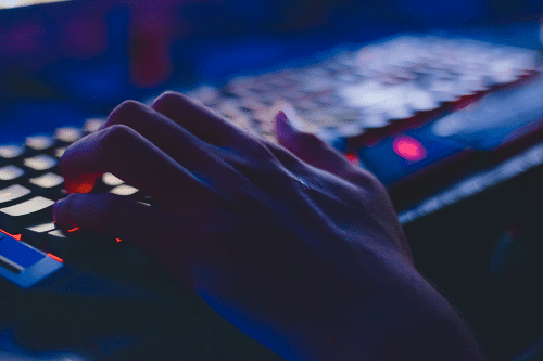 A person typing on a laptop computer